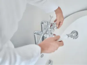 un idraulico installa un rubinetto in una vasca da bagno